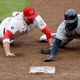 Joey Votto tags out Franmil Reyes at first base as part of a triple play in the eighth inning at Great American Ball Park.